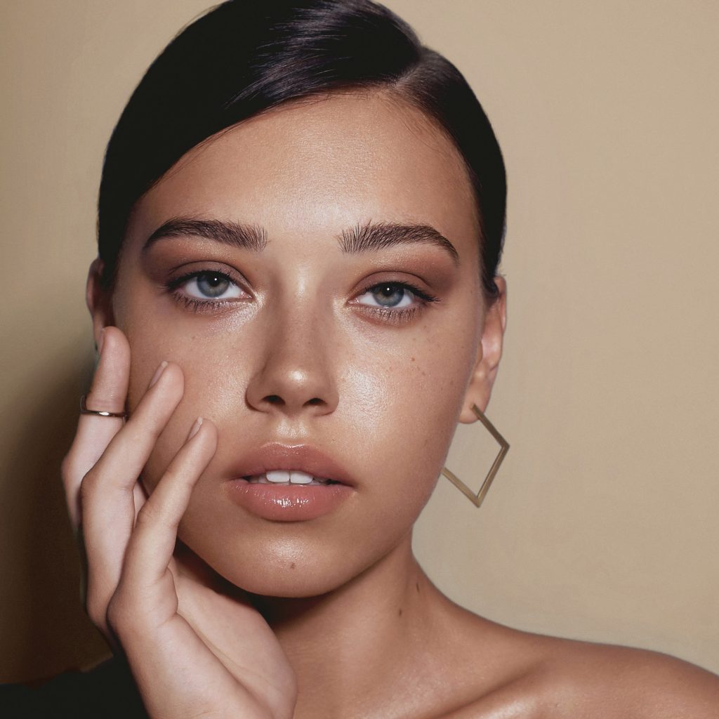 Portrait of tanned girl with big eyes and bright make up